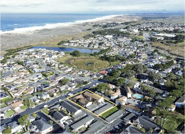 an aerial view of residential building with parking