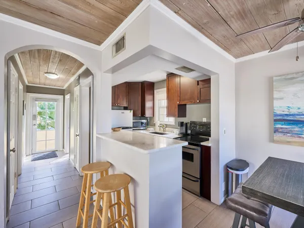 a kitchen with stainless steel appliances kitchen island granite countertop a sink and cabinets