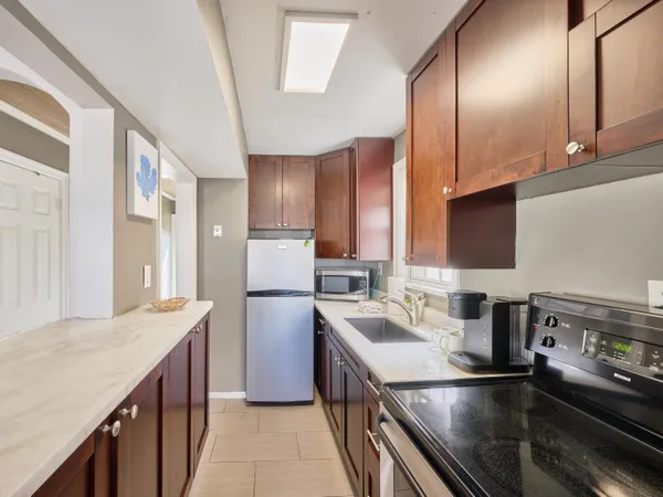 a kitchen with a sink stove and refrigerator