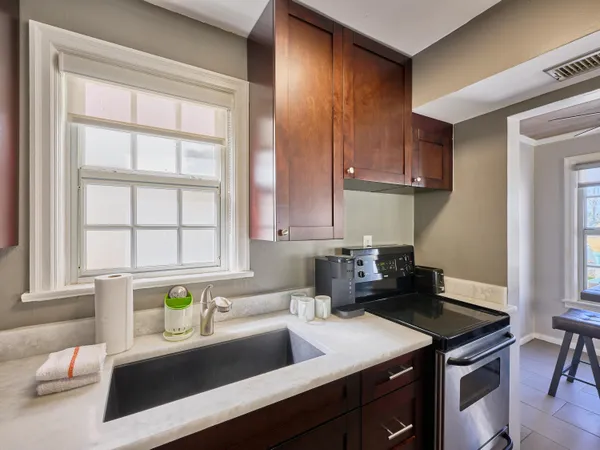 a kitchen with a sink cabinets and window