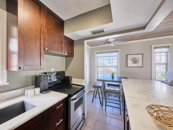 a kitchen with a table chairs in it and wooden floors