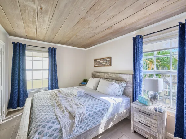 a bedroom with a large bed and a window
