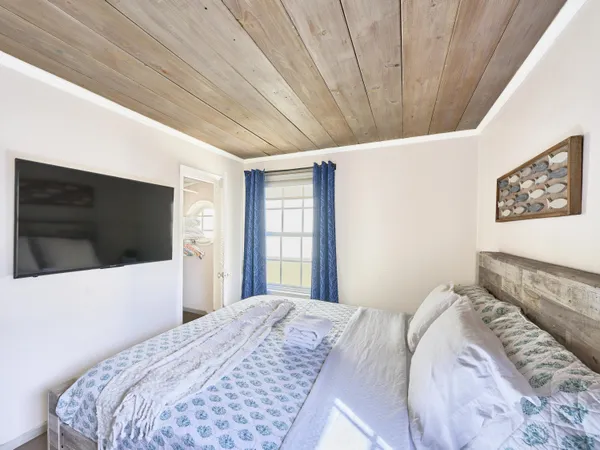 a bedroom with a bed and a television