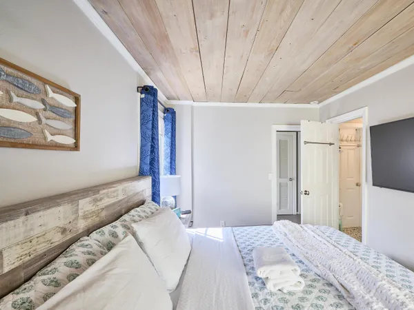a bedroom with a large bed and a chandelier