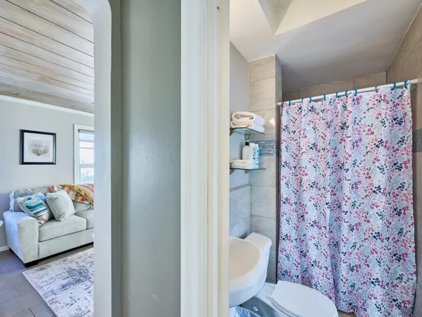 a bathroom with a toilet and a shower curtain