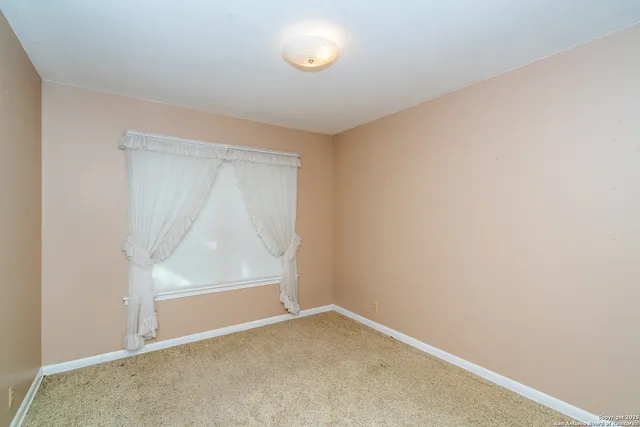 an empty room with closet and a bathroom