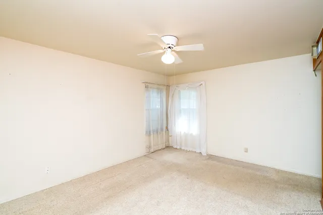 a view of walk in closet with clothes