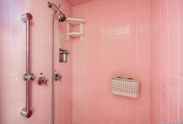 a bathroom with a tub sink and mirror