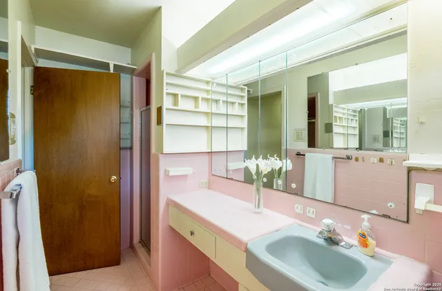 a bathroom with a double vanity sink toilet and a tub
