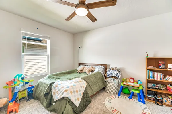 a kitchen with stainless steel appliances kitchen island granite countertop a refrigerator a sink a stove and white cabinets with wooden floor