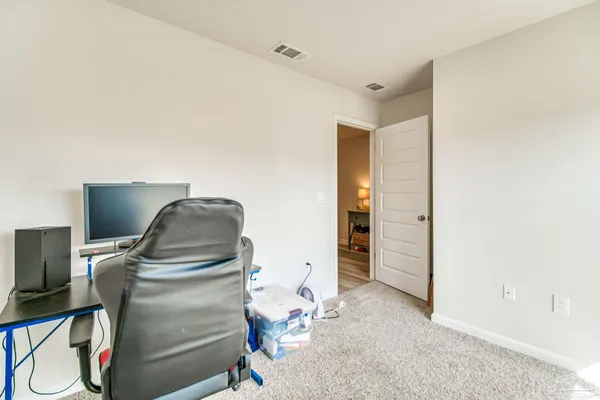 a bedroom with bed and a book shelf