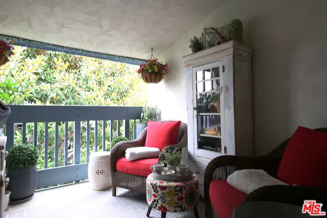 a bedroom with furniture and a large window
