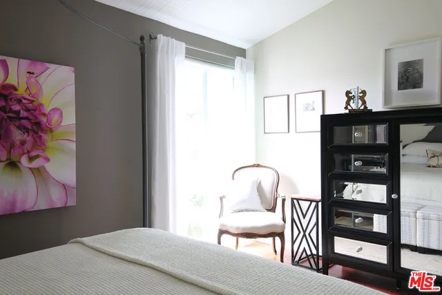 a bedroom with furniture and a window