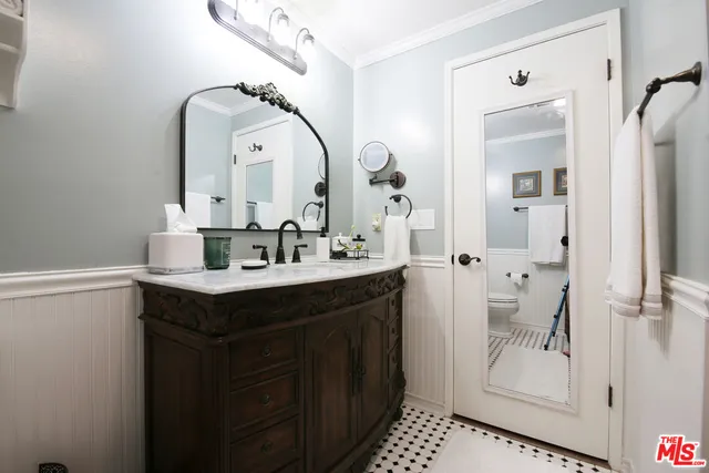 a bathroom with a double vanity sink mirror and shower