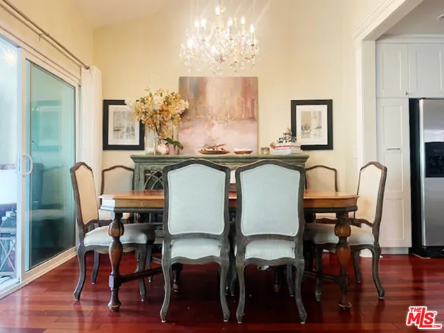 a view of a a dining room with furniture window and wooden floor