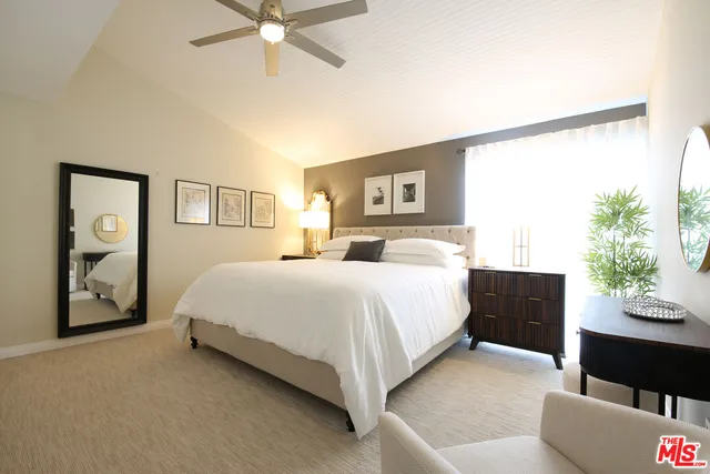 a spacious bedroom with a bed and a couch