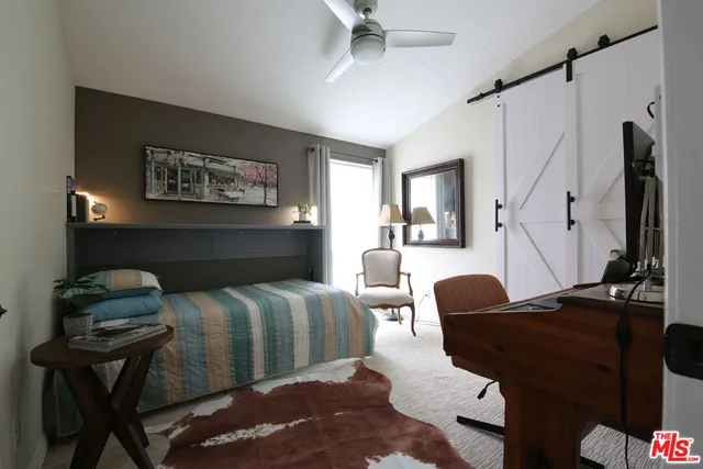 a bedroom with furniture and a window