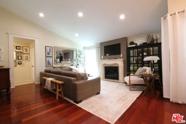 a living room with furniture fireplace and a flat screen tv