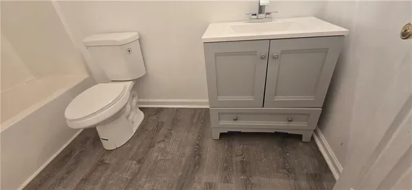 a bathroom with a sink toilet and vanity