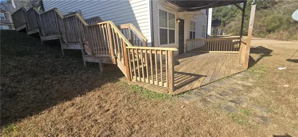 a view of a house with backyard and deck