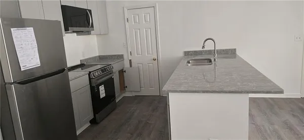 a kitchen with a refrigerator sink and stove