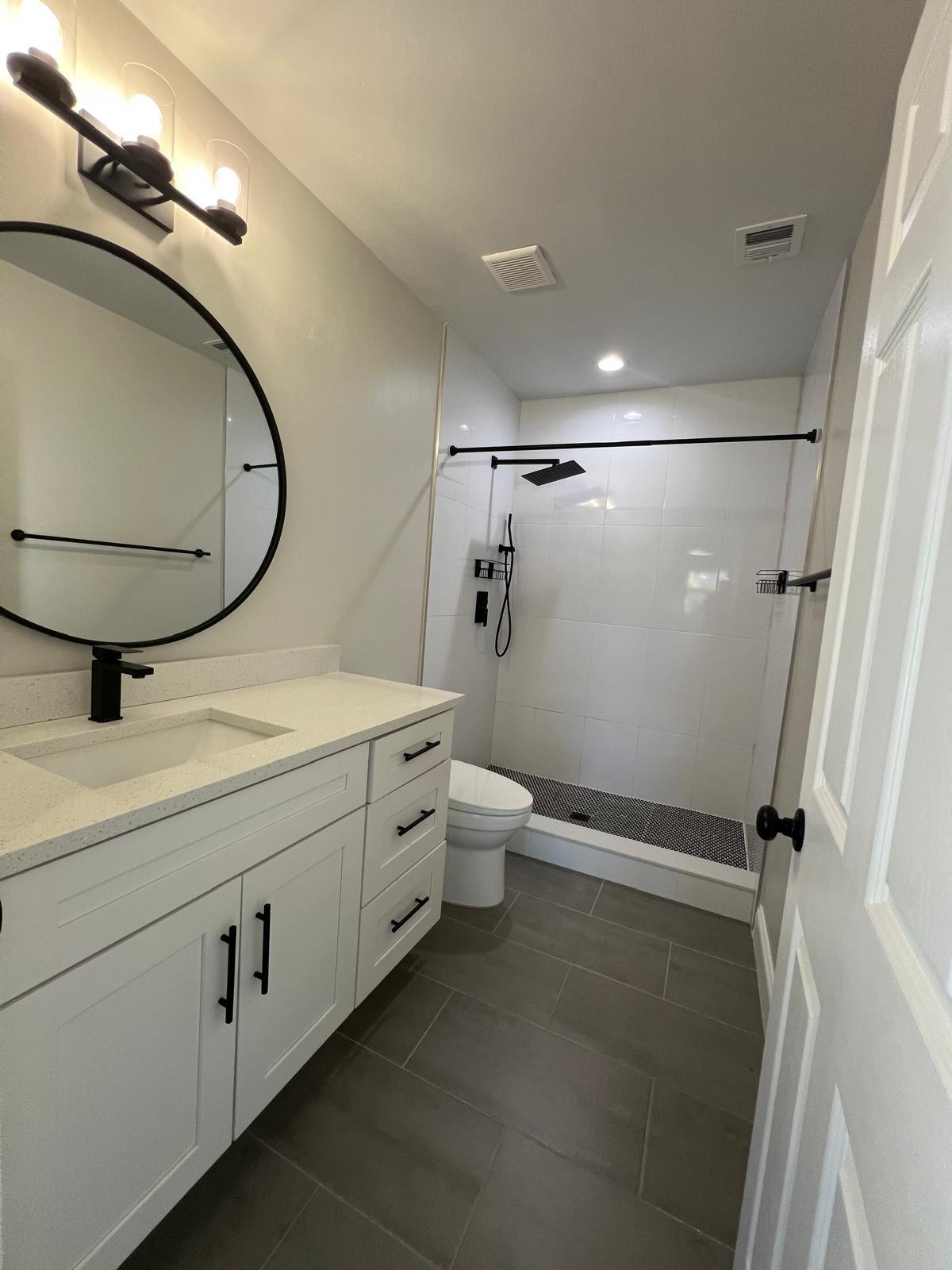 1625 North M Street Lake Worth Beach, FL 33460 - Photo 11 of 23 a bathroom with a double vanity sink toilet and mirror