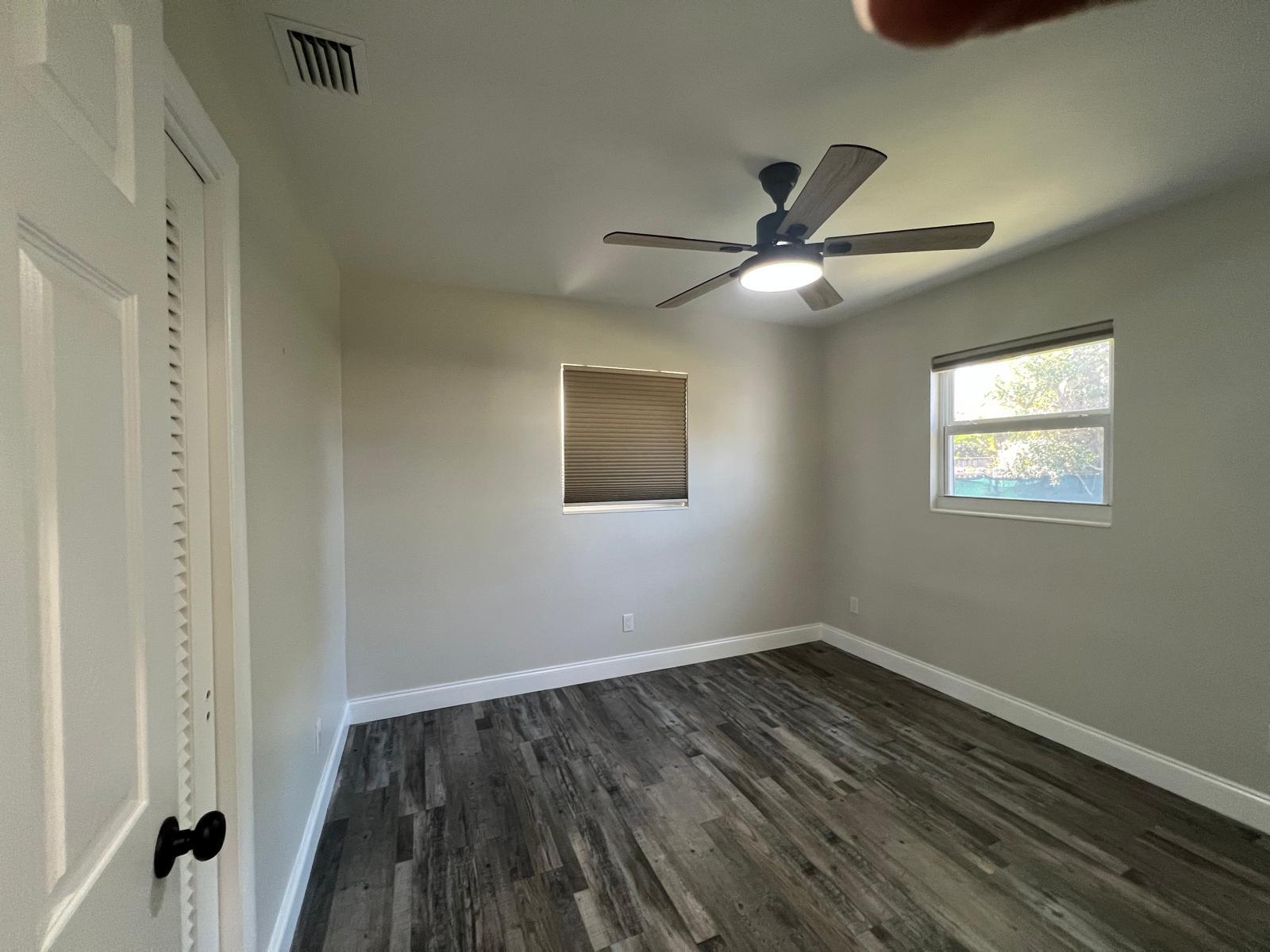 1625 North M Street Lake Worth Beach, FL 33460 - Photo 14 of 23 a view of a room with wooden floor and a ceiling fan
