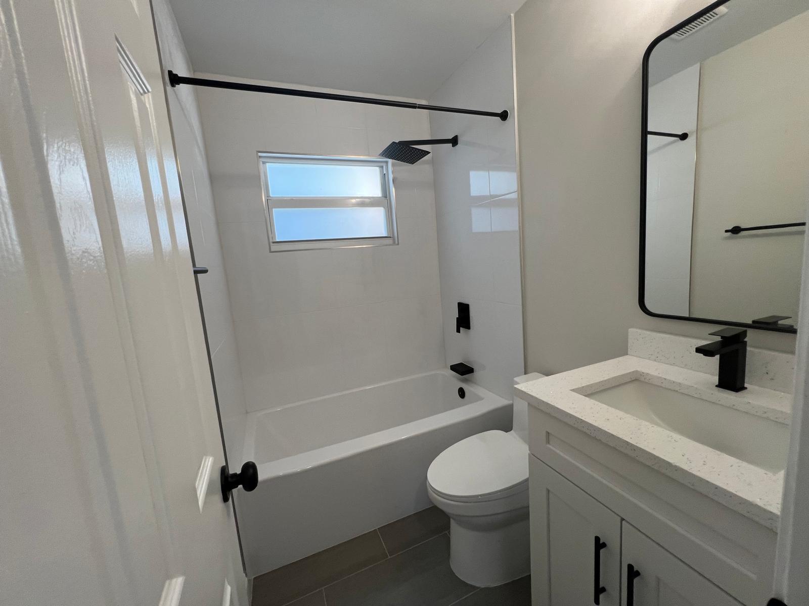 1625 North M Street Lake Worth Beach, FL 33460 - Photo 15 of 23 a bathroom with a sink a toilet a mirror and shower