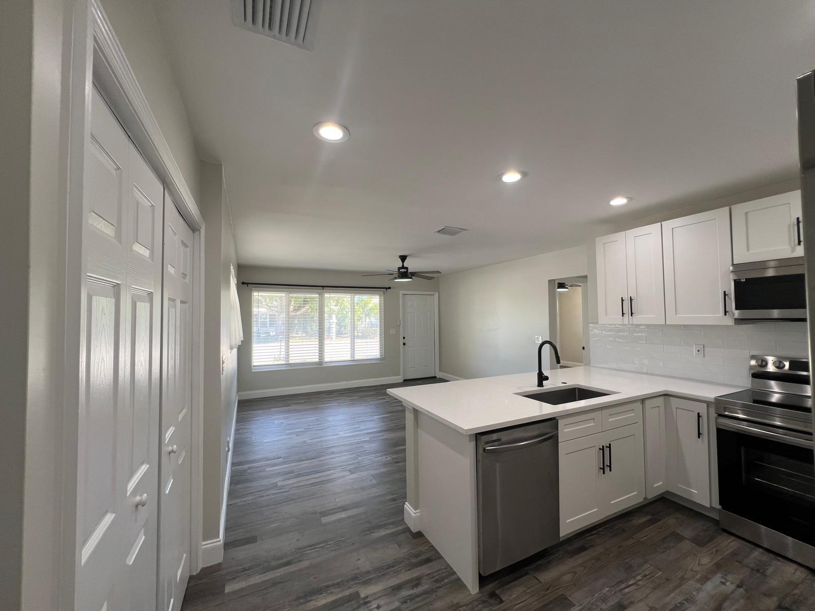 1625 North M Street Lake Worth Beach, FL 33460 - Photo 6 of 23 a view of a kitchen with sink dishwasher and wooden floor