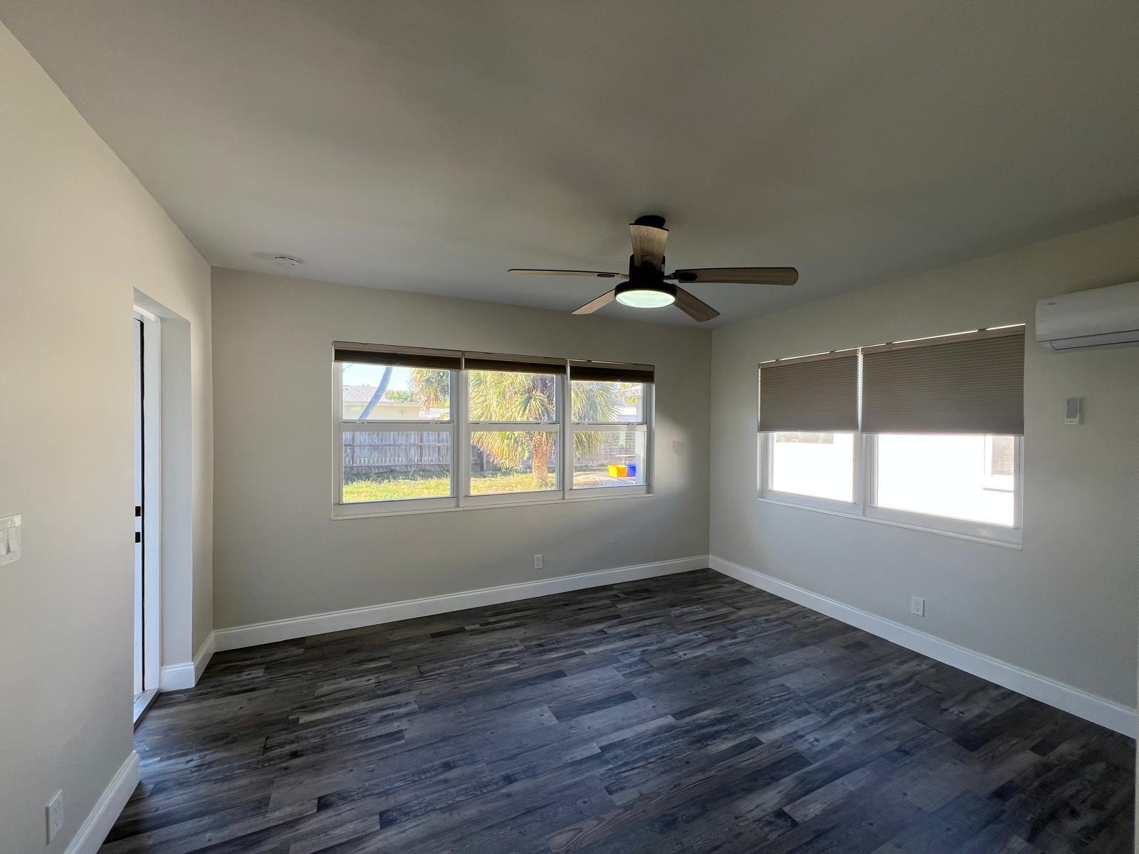 1625 North M Street Lake Worth Beach, FL 33460 - Photo 8 of 23 a view of an empty room with wooden floor and a window