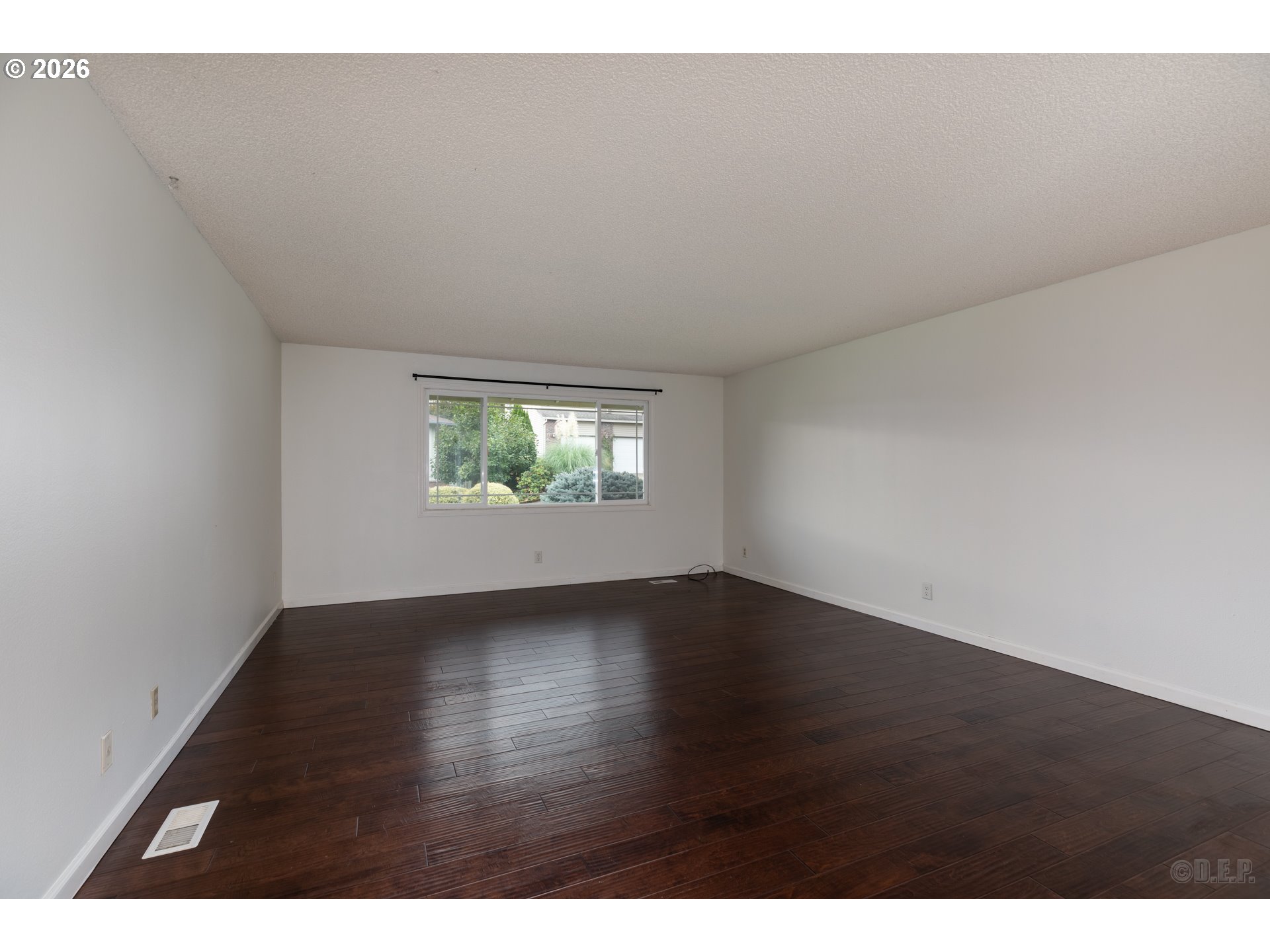 32859 Northwest Overlook Street Scappoose, OR 97056 - Photo 2 of 16 a view of an empty room with wooden floor and a window