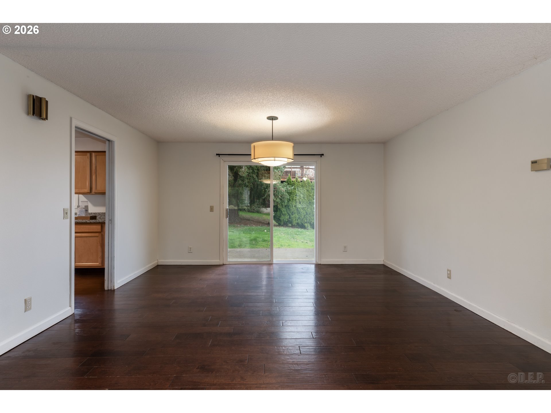 32859 Northwest Overlook Street Scappoose, OR 97056 - Photo 4 of 16 a view of an empty room with wooden floor and a window