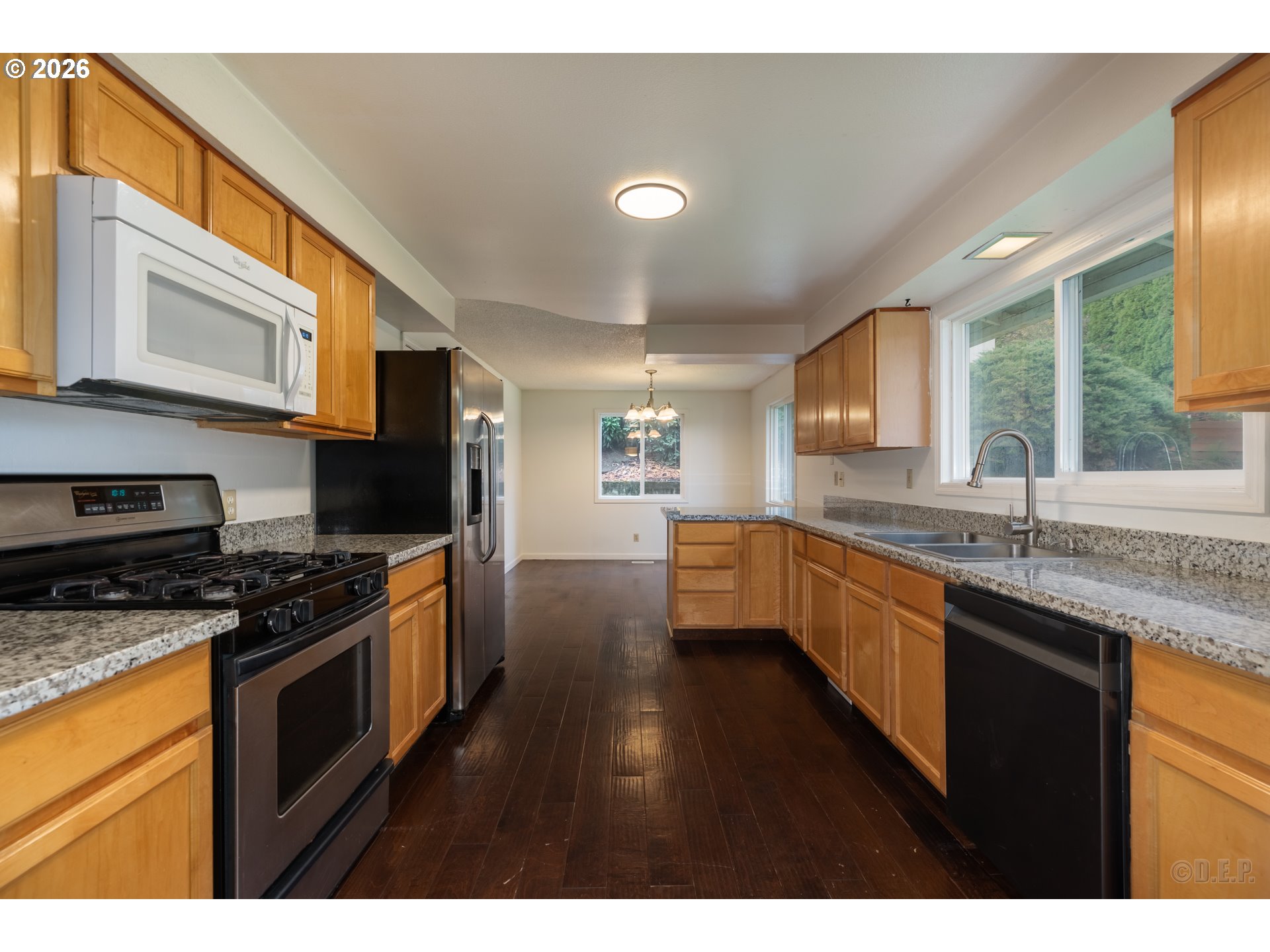 32859 Northwest Overlook Street Scappoose, OR 97056 - Photo 6 of 16 a kitchen with stainless steel appliances granite countertop a stove a sink dishwasher a refrigerator and a microwave