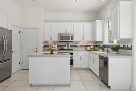 a kitchen with a sink stove and refrigerator