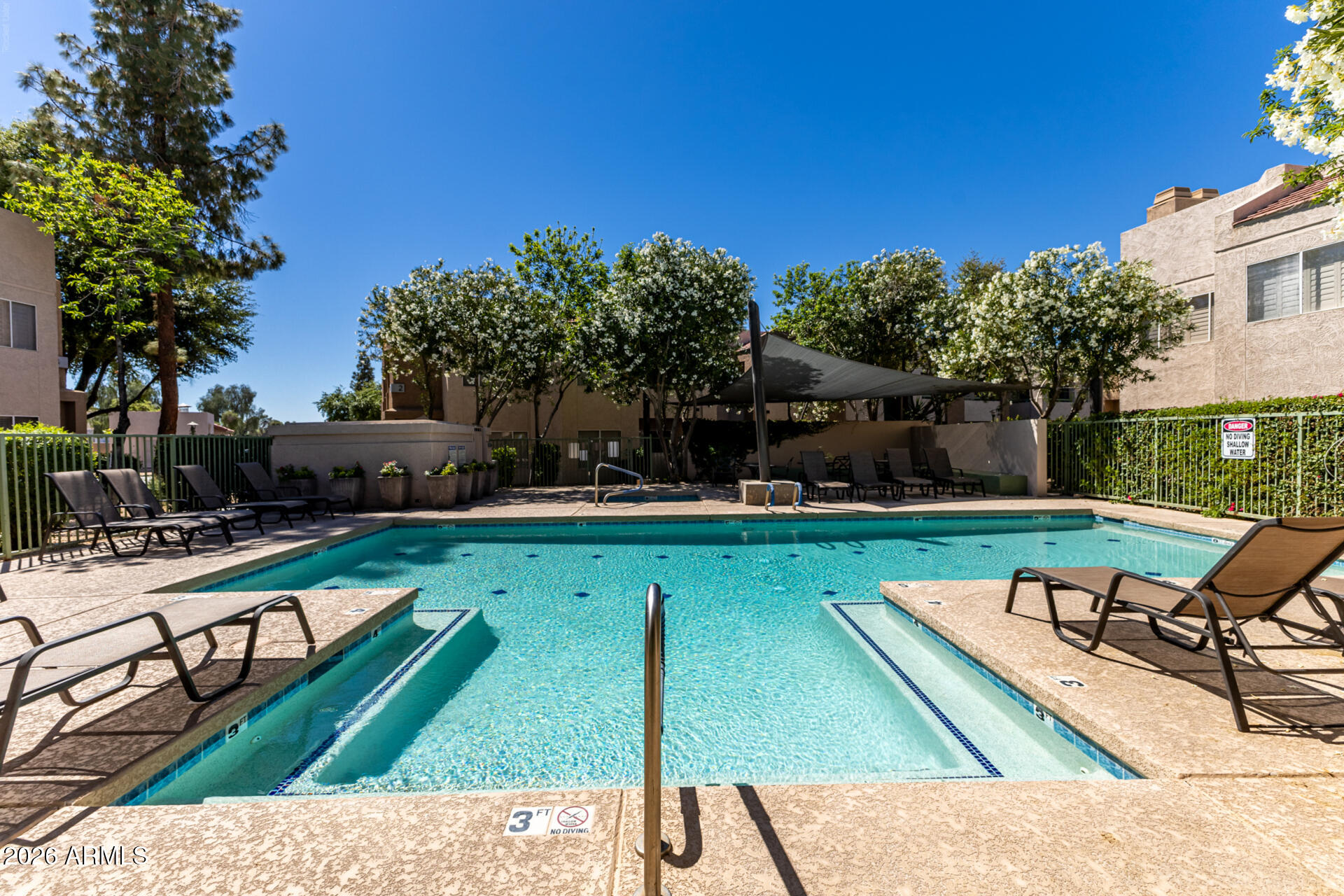 1295 North Ash Street, Unit 828 Gilbert, AZ 85233 - Photo 32 of 43 a swimming pool with outdoor seating and yard