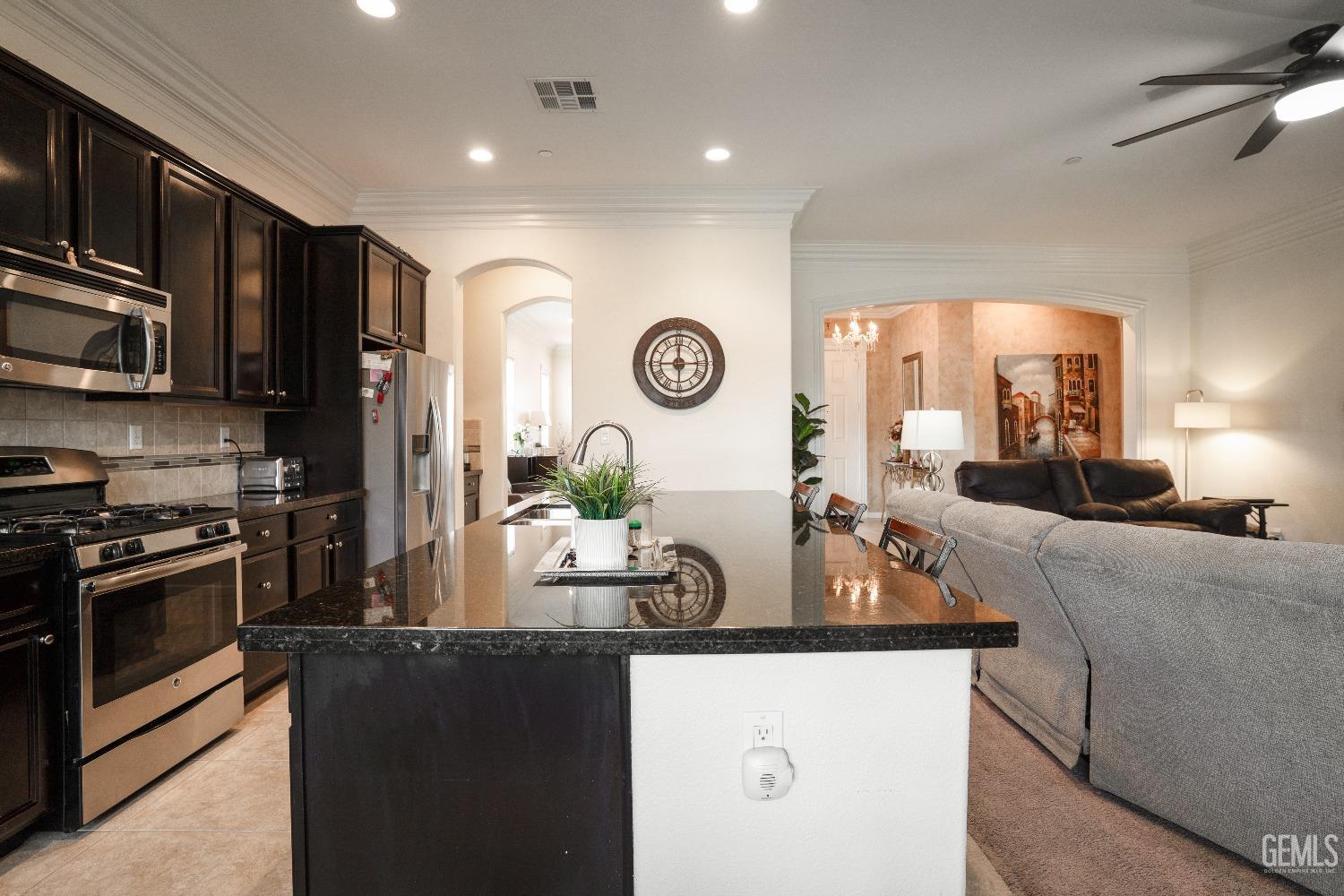 Undisclosed Address Bakersfield, CA 93314 - Photo 13 of 42 a kitchen with stainless steel appliances granite countertop a refrigerator a stove top oven a sink and dishwasher