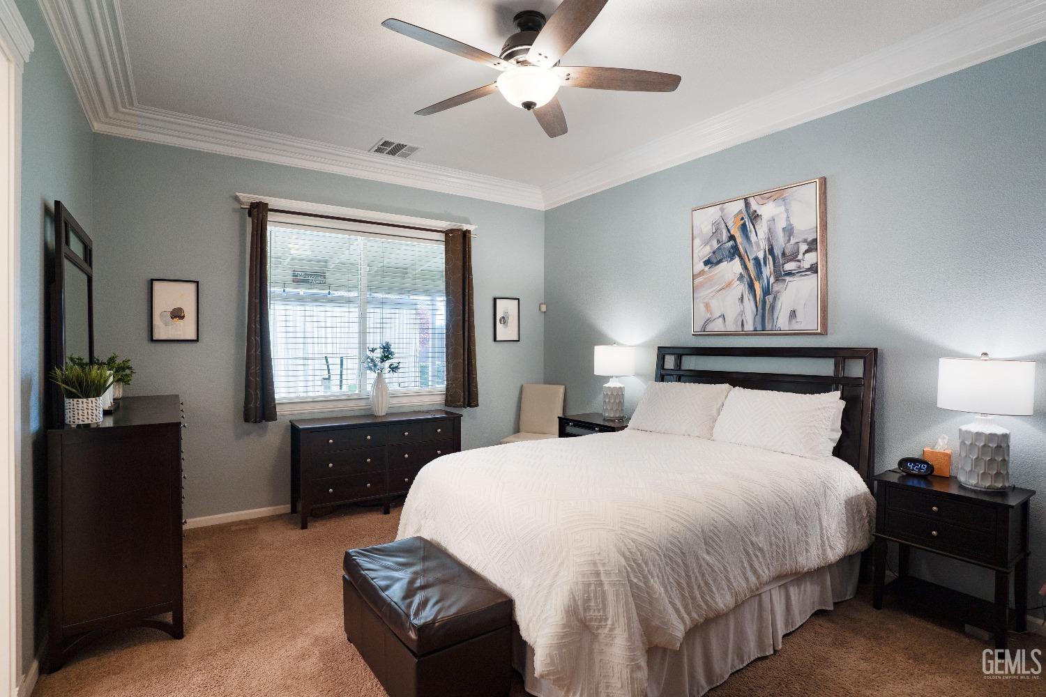 Undisclosed Address Bakersfield, CA 93314 - Photo 33 of 42 a bedroom with a bed and a chandelier