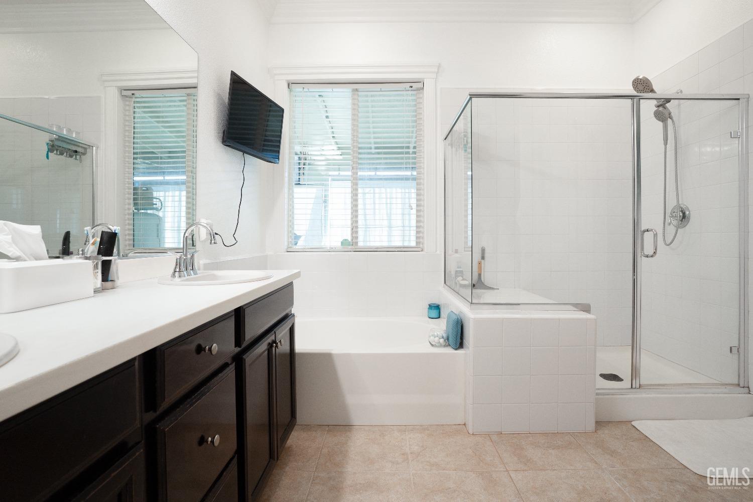 Undisclosed Address Bakersfield, CA 93314 - Photo 36 of 42 a bathroom with a tub sink and mirror
