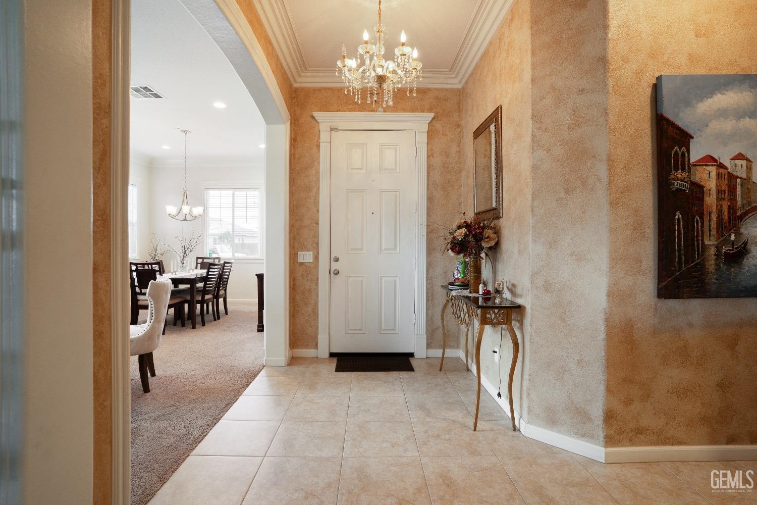 Undisclosed Address Bakersfield, CA 93314 - Photo 6 of 42 a view of a livingroom with a dinning area hardwood floor and a chandelier