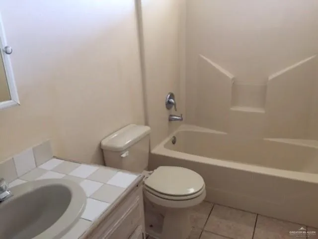 a white toilet sitting next to a bath tub
