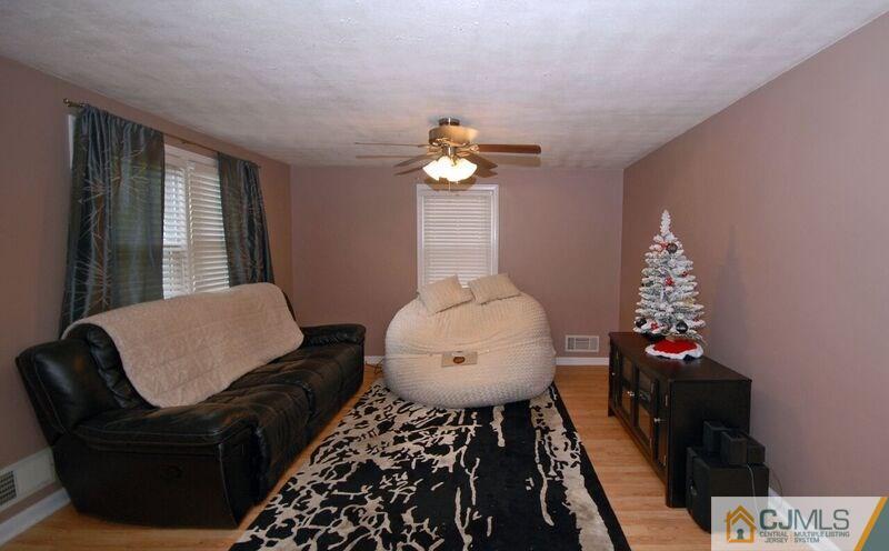 117 2nd Street Dunellen, NJ 08812 - Photo 11 of 25 a living room with furniture and a chandelier