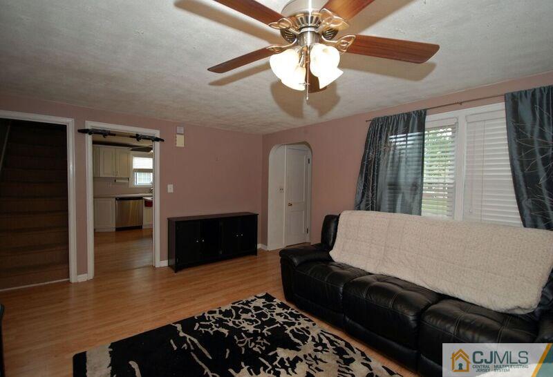 117 2nd Street Dunellen, NJ 08812 - Photo 12 of 25 a living room with furniture and a flat screen tv