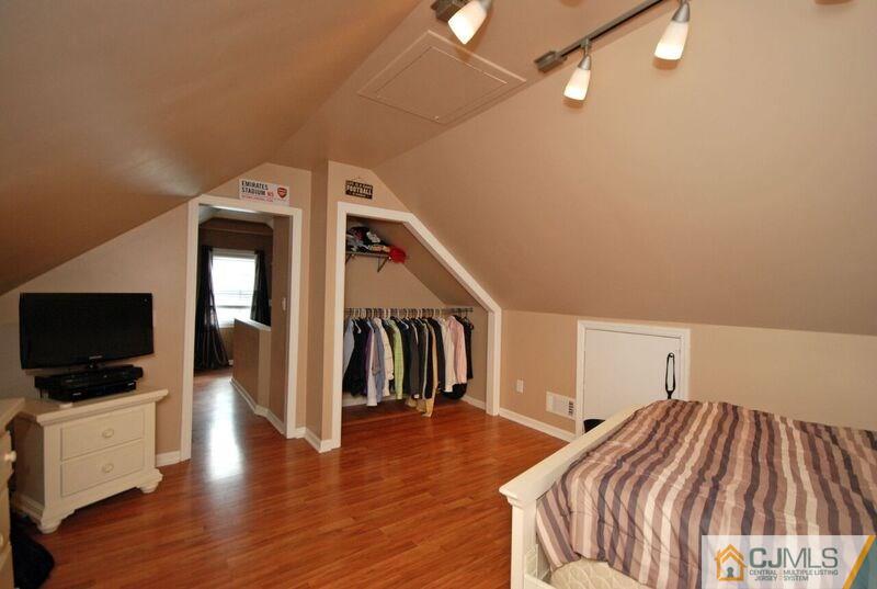 117 2nd Street Dunellen, NJ 08812 - Photo 16 of 25 a bedroom with a bed and a flat screen tv