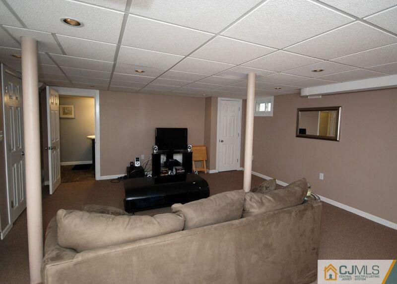 117 2nd Street Dunellen, NJ 08812 - Photo 21 of 25 a living room with furniture and a flat screen tv