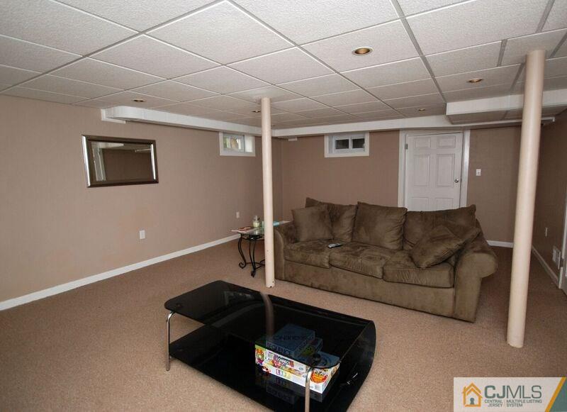 117 2nd Street Dunellen, NJ 08812 - Photo 22 of 25 a living room with furniture and a flat screen tv