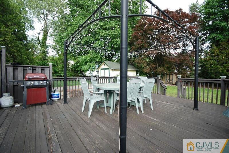 117 2nd Street Dunellen, NJ 08812 - Photo 6 of 25 a view of a chairs and table on the wooden deck