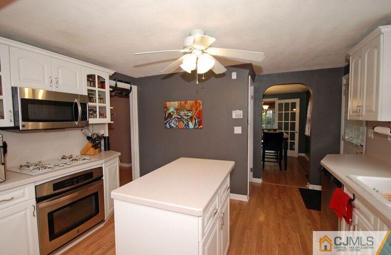 117 2nd Street Dunellen, NJ 08812 - Photo 9 of 25 a kitchen view with microwave a stove and refrigerator