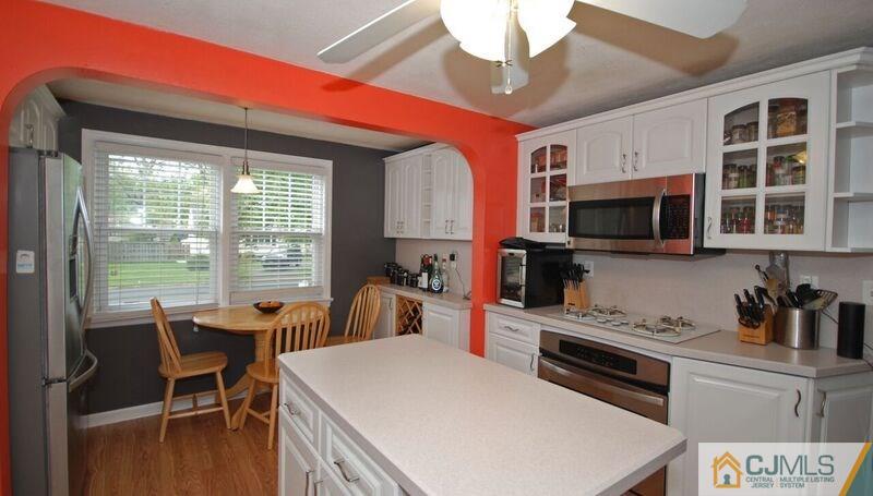 117 2nd Street Dunellen, NJ 08812 - Photo 10 of 25 a kitchen with a stove a sink and a microwave