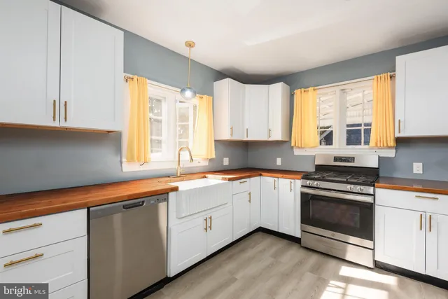 a kitchen with a sink stove and cabinets