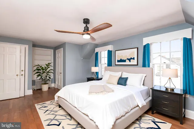a bedroom with a large bed and a chandelier